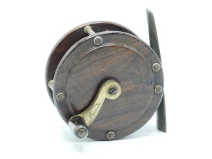 A scarce Anderson & Sons rosewood and brass 3 ¼" salmon winch, tapered cow horn handle on curved crank winding arm with domed iron locking screw, stamped makers name, brass block foot (reduced at one end), triple cage pillars, fixed check mechanism, cir