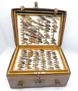 A good C. Farlow & Co. oak salmon fly reservoir and leather case, rectangular reservoir fitted six paper lined lift-out trays, fitted bars of nickel silver spring fly clips and holding a very good selection of 289 fully dressed salmon flies including lar