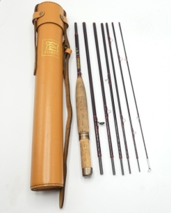 A Hardy "Smuggler Deluxe" 7 piece carbon trout fly rod, 8' 2½", crimson/scarlet tipped silk wraps, anodised sliding alloy reel fitting, spigot joints, light use only, in bag and leather travel tube