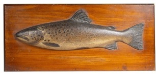 A Fochaber's carved wooden Brown Trout, the naturalistically painted half block fish with painted pectoral and pelvic fin, on chamfered pine backboard, verso stenciled C. Farlow & Co. Ltd. detail, 18 ¾" wide (see illustration)