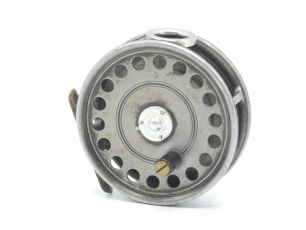 A Hardy St. George 3 ¾" trout fly reel, shallow cored drum with (later) ebonite handle, brass foot, three screw drum latch, (later) white metal line guide, milled rim tension screw and Mk.II check mechanism, 1930's and a Hardy "Glen Beg" 2 piece cane tro