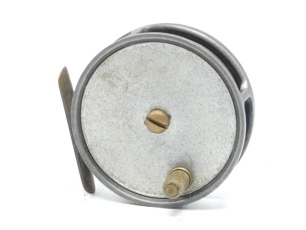 A scarce Hardy Monogram 3 ¼" alloy trout fly reel, unleaded solid drum with xylonite handle and domed brass locking screw, brass foot, fixed Mk.II check mechanism, interior stamped "T.A.G." (Tommy Armstrong), backplate with monogram details and makers na