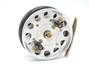 A rare Marston Crosslé "Continental Extension" 3 ¼" centre pin reel, alloy drum with perforated flanged, twin composition handles on shaped brass plates, milled brass tapered drum tension nut, ebonite backplate with brass starback foot (neatly reduced) 