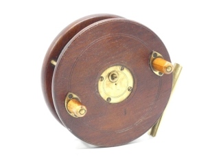 A Slater 5" Nottingham combination centre pin reel, alloy backed mahogany drum with twin horn handles and four screw spring drum latch, annular brass cage, rolling eye line guide, starback foot with sliding optional check button (pawl loose) and stamped