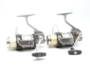 A pair of Abu Suveran S300M fixed spool reels, each with grey anodised finish, folding handle, drum mounted drag adjusting ring, anti-reverse rear spool mounted ring, full bail arm, with four spare spools and instruction manuals, light use (2)