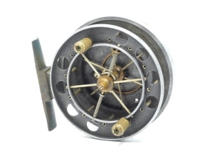 An Allcock Aerial 7950-T3 3 ½" narrow drummed centre pin reel, caged and six spoked drum with twin xylonite handles, perforated front flange (eight holes), stamped "patent" and twin release/regulator forks, brass stancheon foot, rear sliding optional che