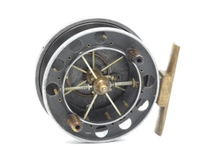 An Allcock Aerial 7950-T2 3 ½" narrow drummed centre pin reel, caged and six spoked drum with twin horn handles, perforated front flange (eight holes), stamped "patent", ebonite rear flange and twin release/regulator forks, brass stancheon foot, rear sli