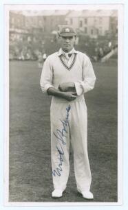 Errol Reginald Thorold Holmes. Surrey, Oxford University & England 1924-1955. Original sepia real photograph postcard of Holmes standing full length wearing cricket attire and cap on the outfield at Scarborough. Very nicely signed in blue ink to the photo