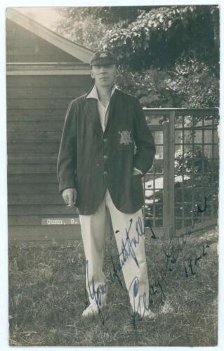 George Gunn. Nottinghamshire & England 1902-1932. Original mono real photograph postcard of Gunn, standing full length wearing Nottinghamshire blazer and cap. The postcard nicely signed in blue ink to the image by Gunn and dated 1922. Blind embossed stamp