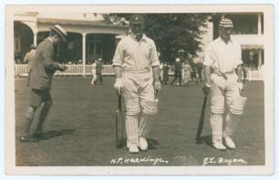 Wally Hardinge and Jack Bryan. Kent. Sepia real photograph postcard of Hardinge and Bryan walking out to bat for Kent with a boy in shorts, jacket and boater close by, spectators in the background. Location, date and photographer unknown, probably late 19