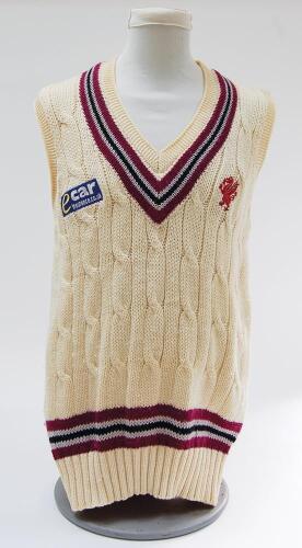 Somerset white 1st XI sleeveless sweater with trimming to collar and waist in club colours, Somerset emblem and sponsors logo ‘Ecar Insurance’ to chest. Size 44”. Player unknown. Good condition