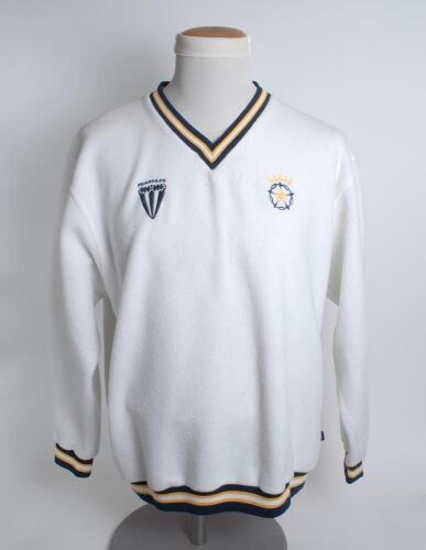 Hampshire white 1st XI long sleeved fleece overtop/sweater with trimming to collar, waist and cuffs in club colours, Hampshire emblem and sponsors logo ‘Fearnley’ to chest. Size ‘Large’. Player unknown. Good condition