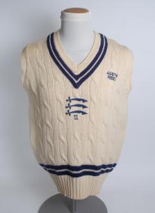 Middlesex white 2nd XI sleeveless sweater, by F.A.B. Knitwear, with trimming to collar and waist in club colours, Middlesex emblem and ‘II’ to the centre and sponsors logo ‘Austin Reed’ of chest. Size 44”. Player unknown. Good condition