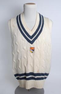 Norfolk white 1st XI sleeveless sweater, by ‘Allez’, with trimming to collar and waist in club colours, Norfolk emblem to chest. Size 44”. Player unknown. Good condition