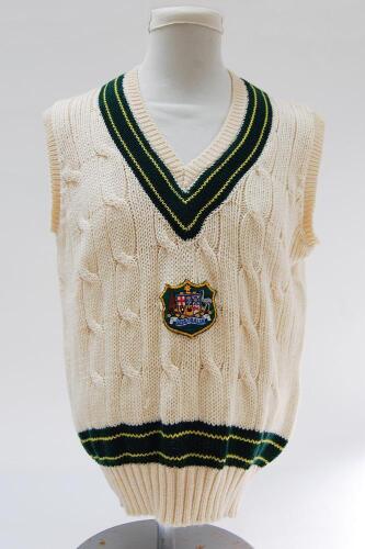 Australian Test sleeveless sweater with Australian emblem in shield to chest and trimming to neck and waist in Australian colours of green and gold. Size 42”. Player unknown. Good/very good condition