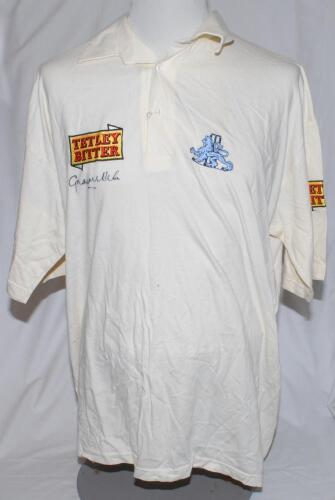 Graeme Hick, Worcestershire & England. England short sleeve white Test shirt by ‘ams’, with embroidered three lion and stumps emblem of England to chest, and ‘Tetley Bitter’ emblem to chest and sleeve. Size XL. The shirt match worn and signed by Hick to t