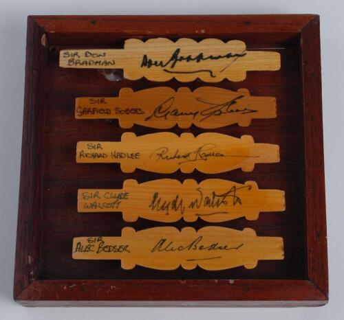 ‘Cricketing Knights (Knighthoods awarded for Services to Cricket’. Five cricket bails, halved and nicely signed in ink by five cricketing knights. Signatures are Don Bradman, Garry Sobers, Richard Hadlee, Alec Bedser and Clyde Walcott. The bails varnished