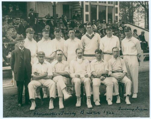 Surrey C.C.C. 1922. Official mono photograph of the Surrey team for the match played v Gloucestershire at Bristol 27th- 30th May 1922. The players are seated and standing in rows wearing cricket attire, set in front of the pavilion with spectators looking