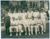 Surrey C.C.C. 1922. Official mono photograph of the Surrey team for the match played v Gloucestershire at Bristol 27th- 30th May 1922. The players are seated and standing in rows wearing cricket attire, set in front of the pavilion with spectators looking