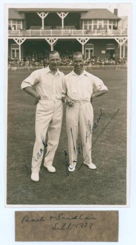 ‘Peach & Sandham’ Surrey 1929. Original sepia real photograph plain back postcard of Alan Peach and Andy Sandham standing side by side on the outfield wearing cricket attire at Scarborough with the pavilion in the background. Both players appeared for Lor