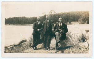 M.C.C. tour to Australia 1922/23. Original mono postcard size candid style photograph of Tich Freeman and Maurice Tate with one other, all dressed in suits and seated on a rock by a lake while on tour. Photographer unknown. Ex Freeman collection. Good/ ve