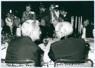 Don Bradman. Original mono photograph of Bradman seated next to Bob Hawke, Australian Prime Minister with their backs to the camera, at a dinner to honour Bradman held at the Regent Hotel, Sydney, 13th October 1989. Signed in ink by Bob Hawke and his wife