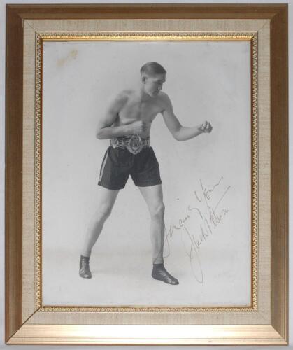 Jack Petersen. British and Empire (Commonwealth) Heavyweight Champion 1930s. Large original mono studio photograph of Peterson in boxing pose wearing his Lonsdale Belt. Nicely and boldly signed in gold ink by Peterson. Photographer’s signature in pencil t