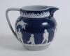 Golf jug. An attractive Copeland Late Spode jug, the body decorated with a continuous scene of golfers and caddies in white raised relief displaying various golfing swings and poses on a cobalt blue and grey ground with floral decoration. Circa 1910. 4.75 - 2