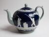 Golf teapot. A very attractive Copeland Late Spode teapot, the body decorated with a continuous scene of golfers and caddies in white raised relief displaying various golfing swings and poses on a cobalt blue and grey ground with floral decoration. Circa 