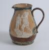 Royal Doulton Lambeth Golf jug. An attractive Royal Doulton Lambeth stoneware jug with strap handle, of bulbous form, with art nouveau design with scrolled foliate borders, enriched in green, blue and brown glazes, with three golfing scenes in white relie