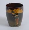 Royal Doulton Kingsware brown beaker with a cavalier golfer (Charles Crombie) to one side and a caddie to verso. Royal Doulton mark to the bottom of the beaker. 4” tall. Circa 1930. Very good condition