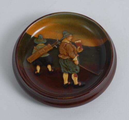 Royal Doulton Kingsware brown bibelot dish with a cavalier golfer and caddie (Charles Crombie) to surface. ‘Ye 19th Hole’ and Royal Doulton to the base. 4.5” diameter. Circa 1910. Very good condition