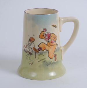 Royal Doulton tall mug with illustration by artist H.M. Bateman showing an irate golfer throwing his club and kicking his bag to one side and three other golfers laughing to the other. 5.5” tall, circa 1937. Doulton mark and number D5813 to base. Very goo