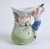 Golf jug. Ceramic jug with scenes of golf and a golf course to jug, handle design of a golfer playing a drive. Leonardo. 7” tall. Two chips to spout otherwise in good condition