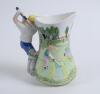 Golf jug. Ceramic jug with scenes of golf and a golf course to jug, handle design of a golfer playing a drive. Leonardo. 7” tall. Two chips to spout otherwise in good condition - 2