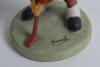 Humorous figure of a golfer with golf ball head and face. Made by Wiltshaw & Robinson, Stoke on Trent. Carlton China No.0119427. The golf ball head is attached to elastic enabling the head to move around. Signature of artist Hassall to green base. 5.25”. - 2