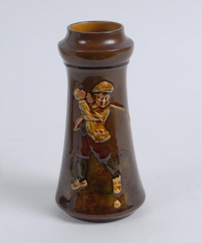 Boy Golfer. A brown vase with figure of a boy golfer playing a shot. 7.75” tall. Similar to a Royal Doulton Kingsware, no marks to base. Good condition