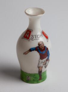 Aston Villa. Original ‘Grays Sports China’ Aston Villa miniature ople shaped vase circa 1911. The vase inscribed in enamel ‘ASTON VILLA’ with a Villa player dressed in claret and blue strip and football to side, the reverse with a panel listing the clubs