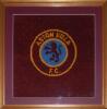 Aston Villa F.C. Original and impressive framed square section of carpet reclaimed from the entrance to the Trinity Road stand when demolished, 20th May 2000. The section bears the circular Club emblem of rampant lion on blue background to the centre surr