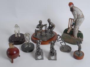 Cricket ceramics and metalware. A good selection including a W.G. Grace doorstop, metal display of batsman and wicket keeper by Evergreen Studio, two smaller metal figures of batsman with mounted clock beneath, a cricket ball cigarette lighter, a metal fi