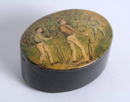 Cricket snuff box. An oval black lacquered papier mache snuff box with hinged lid, believed to be circa 1870&rsquo;s. The lid painted with a cricketing scene of boys playing cricket with trees in background. The box measures approx 2.75&rdquo; x 2&rdquo;x 1.25&rdquo; deep. Good 