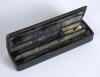 Cricket pencil case. A black laquered papier mache oblong pencil case with hinged lid, believed to be circa 1870/80&rsquo;s. The lid painted with a cricketing scene of boys playing cricket with trees in background. Still containing some of its contents. The cas - 2