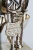 Cricket themed egg cup presentation piece. A unique set of four silver-plated egg cups with accompanying spoons on an ornate square based stand with ball feet. The centre piece holding the spoons with crossed bats, ball and wicket decoration. The shield - 2