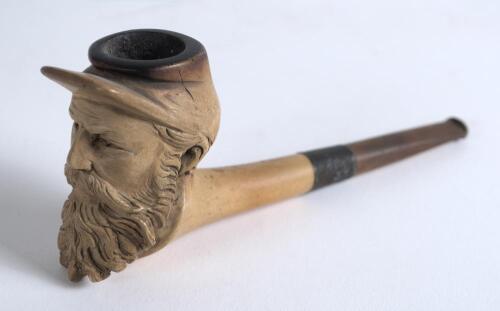 Meerschaum smoking pipe. Beautifully carved pipe with bearded head looking a lot like W.G. Grace but by the tilt of his cap could equally be a American civil war soldier. Silver band to stem. 5.5&rdquo; long. Good condition