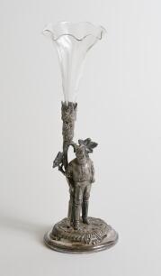 W.G. Grace. A silver plated tulip vase cast in the form of W.G. Grace, full length standing in classic pose with cricket bat in front of a tree. With original glass flute in holder to top of tree. Circa 1900 with number &lsquo;11445&rsquo; to base and makers marks to