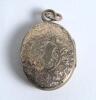 Cricket locket. Silver base metal oval shaped opening locket with enamelled (?) figure of a batsman playing a shot to lid, decorative floral back. Date unknown circa 1940/50&rsquo;s (?). Minor signs of wear otherwise in good condition - 3