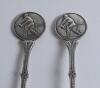 Cricket spoons. A pair of silver plated spoons each with a similar figure of a batsman at the wicket to top of handle. Sold with a small ceramic cricket cup with image of a batsman and a golfing saucer, cracks to the saucer. G - 2