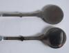 Cricket spoons. A pair of silver plated spoons each with a similar figure of a batsman at the wicket to top of handle. Sold with a small ceramic cricket cup with image of a batsman and a golfing saucer, cracks to the saucer. G - 3