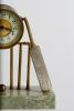 Cricket clock. A Victorian brass mantel clock. An attractive late Victorian/ Edwardian brass clock of cricketing interest, formed with a central drum form enamelled dial and workings attached two sets of cricket stumps and bails with cricket bats leaning - 2