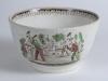 Village cricket bowl. Staffordshire 19th century bowl, transfer printed in sepia with three scenes of village cricket, with church and tents to background, to sides, floral and oak leaf inner rim decoration. Hand coloured in green and burgundy. Approx 6.5 - 2